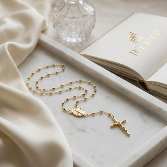 14K Yellow Gold Beaded Station Chain with Cross, 26 Inch, on marble vanity tray with silk