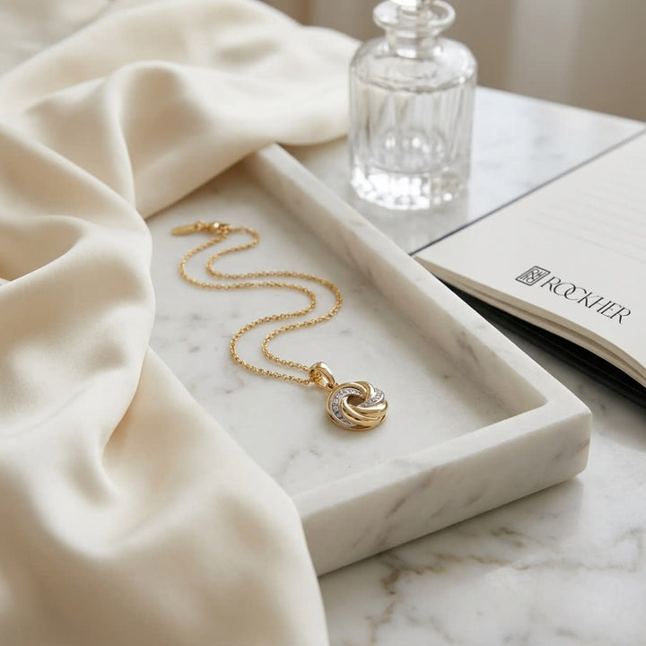 14K Tri-Color Gold Love Knot Pendant Necklace, 18 Inch, on marble vanity tray with silk