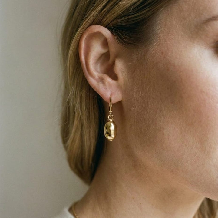 14K Yellow Gold Polished Drop Earrings, worn close-up portrait