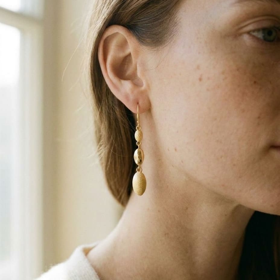 14K Yellow Gold Elongated Drop Earrings, worn close-up portrait