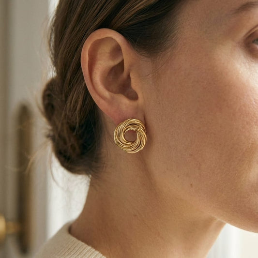 14K Yellow Gold Love Knot Stud Earrings, worn close-up portrait