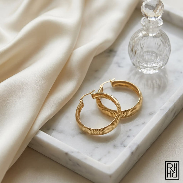 14K Yellow Gold Striped Hoop Earrings, on marble vanity tray with silk