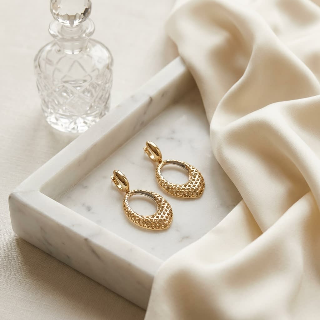 14K Two-Tone Gold Twisted Oval Drop Earrings, on marble vanity tray with silk