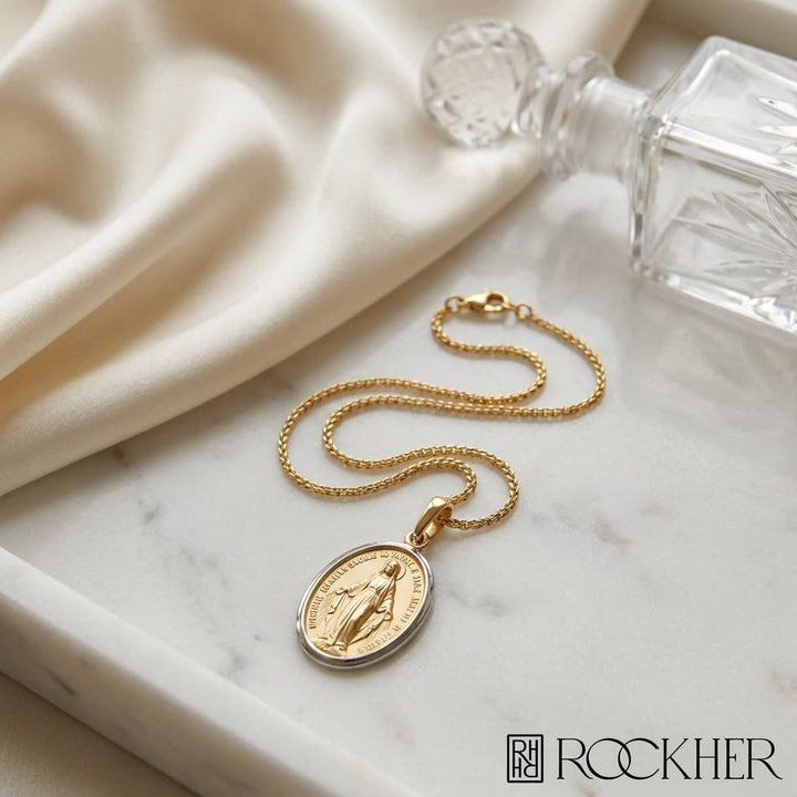 14K Yellow Gold Oval Virgin Mary Medal Necklace, 17 Inch, on marble vanity tray with silk