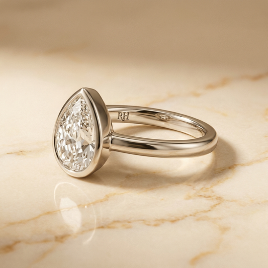 The Agnes Select bezel solitaire briolette engagement ring in 18k white gold — alt-angle hero — RockHer