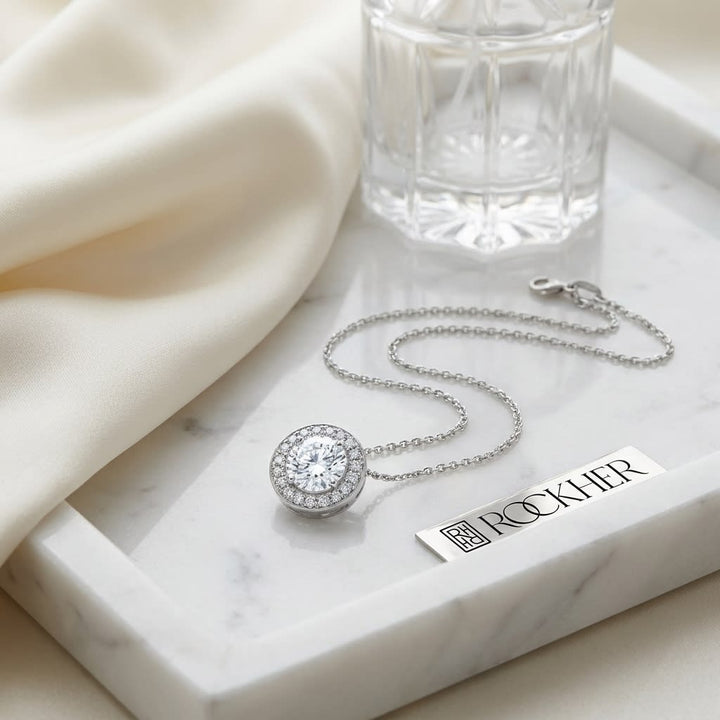 Natural Diamond Round Brilliant Halo Pendant in 18K White Gold, 0.7 ct. t.w., on marble vanity tray with silk