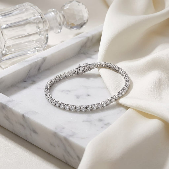 Diamond 4-prong Tennis Bracelet in 18K White Gold, on marble vanity tray with silk