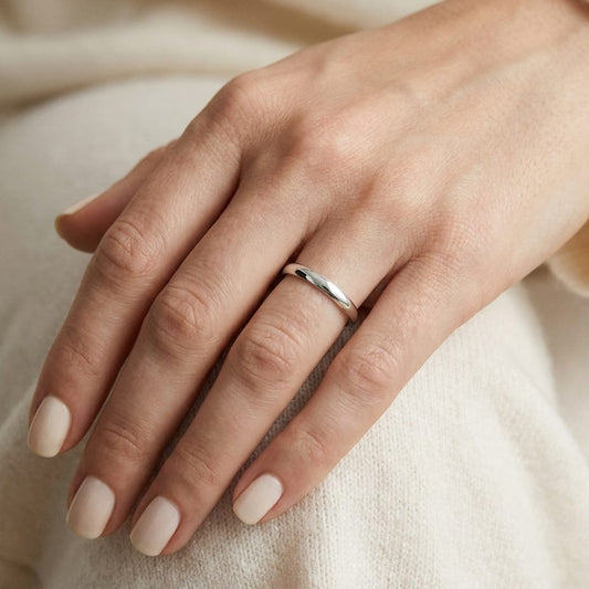 2mm Slightly Domed Traditional Oval Wedding Band in 18K White Gold, worn on hand, close-up