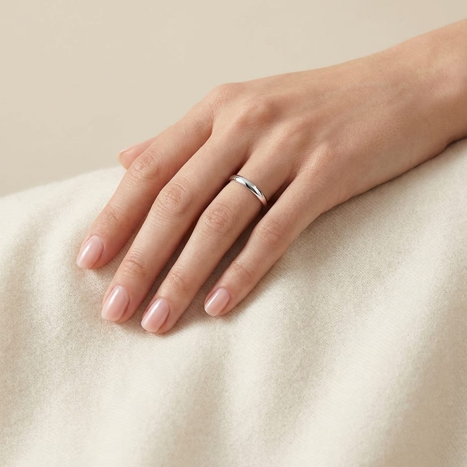 2mm Slightly Domed Traditional Oval Wedding Band in 18K White Gold, worn on hand, full view