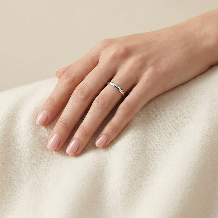 2mm Slightly Domed Traditional Oval Wedding Band in 18K White Gold, worn on hand, full view