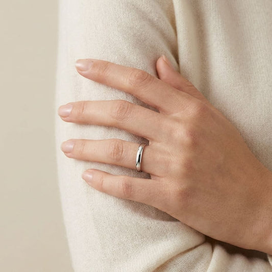 2.5mm Slightly Domed Traditional Oval Wedding Band in 18K White Gold, worn on hand, full view