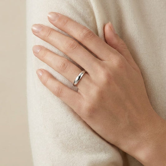 4mm Slightly Domed Traditional Oval Wedding Band in 18K White Gold, worn on hand, full view