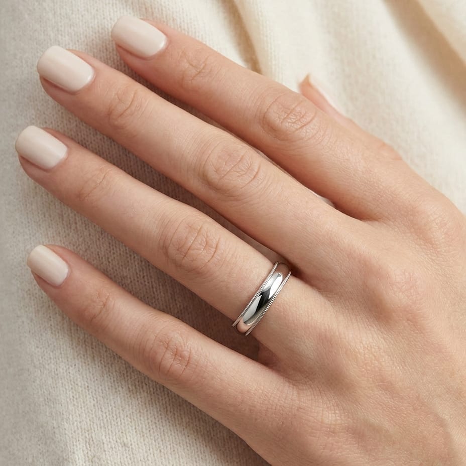 4mm Slightly Domed Traditional Oval Milgrain Wedding Band in 18K White Gold, worn on hand, close-up