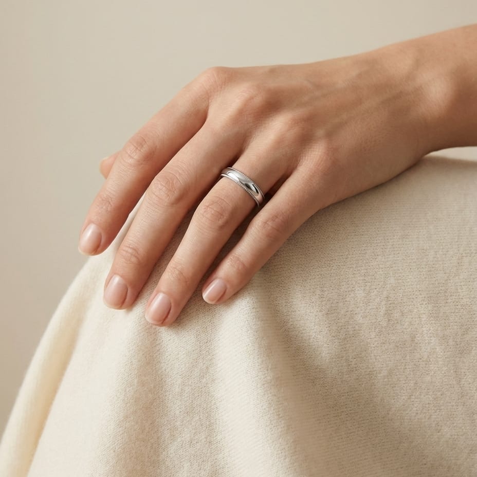 4mm Slightly Domed Traditional Oval Milgrain Wedding Band in 18K White Gold, worn on hand, full view