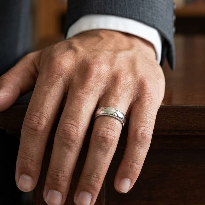 6mm Slightly Domed Traditional Oval Milgrain Wedding Band in 18K White Gold, worn on hand, masculine close-up