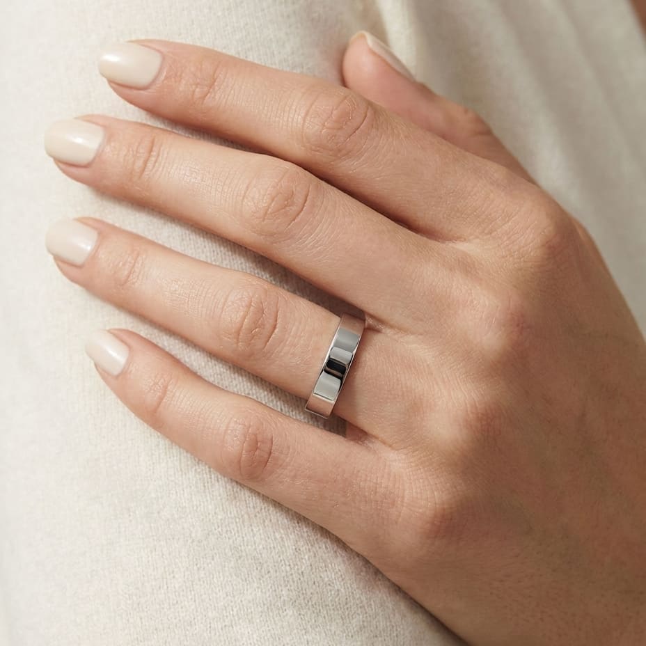 4mm Flat Comfort-Fit Wedding Band in 18K White Gold, worn on hand, close-up