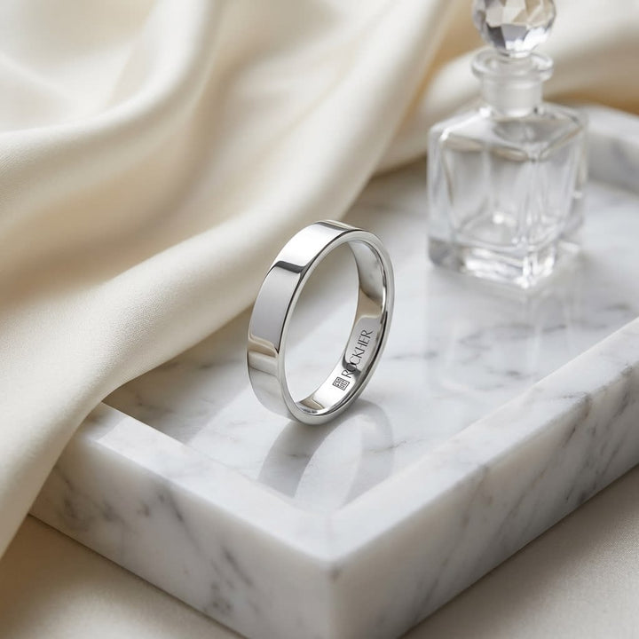 4mm Flat Comfort-Fit Wedding Band in 18K White Gold, on marble vanity tray with silk