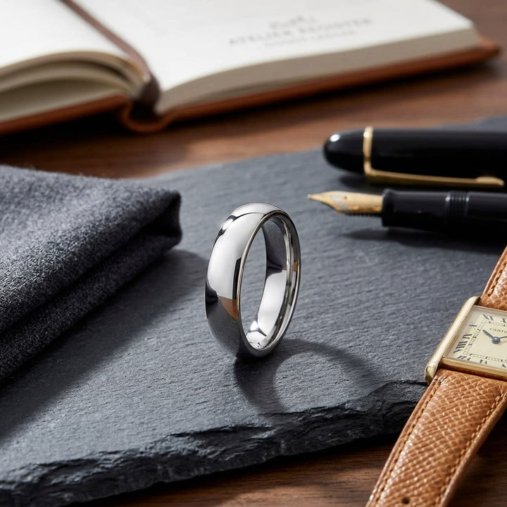 5.5mm Deluxe Comfort-Fit Wedding Band in 18K White Gold, on walnut surface with pocket square