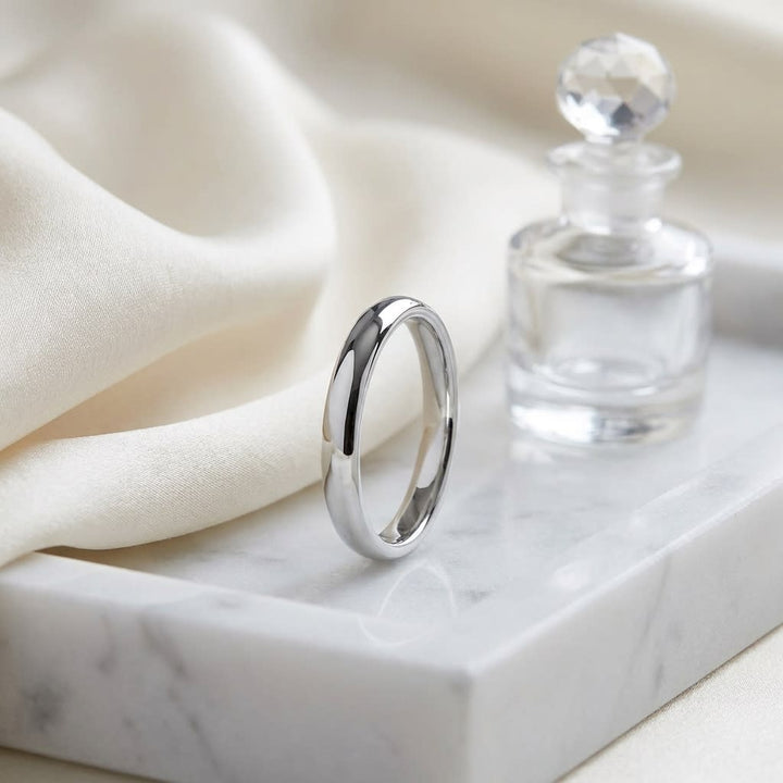 3mm Slightly Domed Comfort-Fit Wedding Band in 18K White Gold, on marble vanity tray with silk