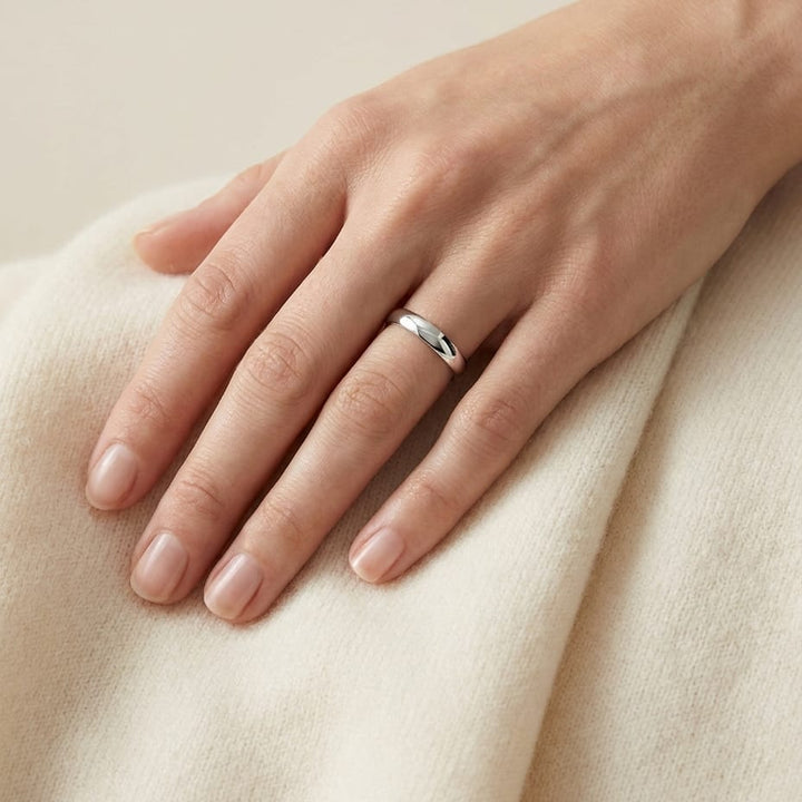 4mm Slightly Domed Comfort-Fit Wedding Band in 18K White Gold, worn on hand, full view