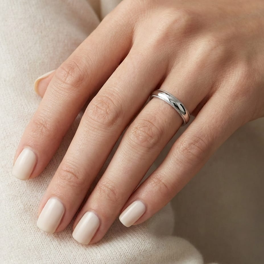 4mm Slightly Domed Double Milgrain Comfort-Fit Wedding Band in 18K White Gold, worn on hand, close-up