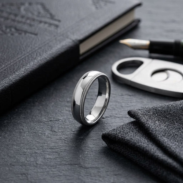 5mm Slightly Domed Double Milgrain Comfort-Fit Wedding Band in 18K White Gold, on walnut surface with pocket square