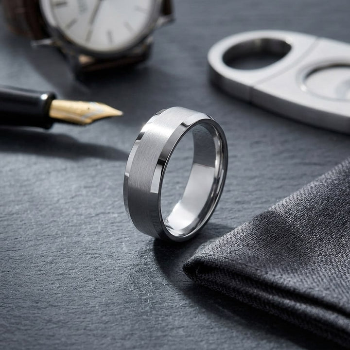 7mm Satin Finish High Polished Beveled Edge Carved Wedding Band in 18K White Gold, on walnut surface with pocket square