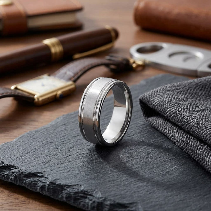 8mm Satin Finish Milgrain Round Edge Carved Wedding Band in 18K White Gold, on walnut surface with pocket square