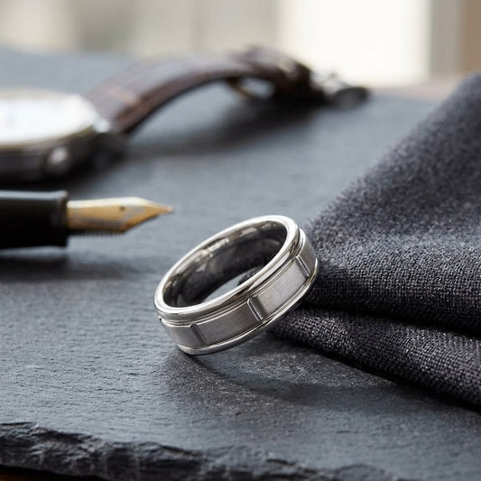6mm Satin Finish High Polished Center Cut Carved Wedding Band in 18K White Gold, on walnut surface with pocket square