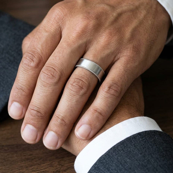 8mm Satin Finish Carved Wedding Band in 18K White Gold, worn on hand, masculine close-up
