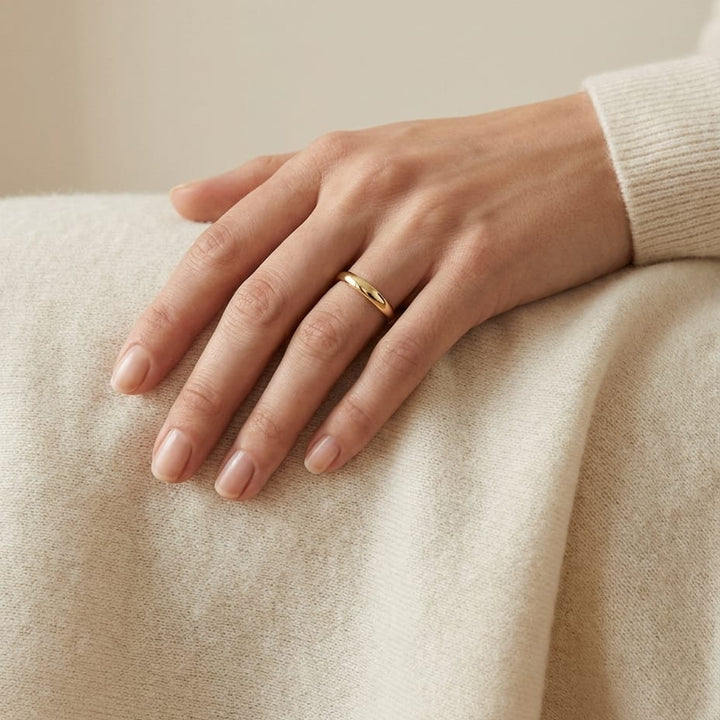 2mm Slightly Domed Traditional Oval Wedding Band in 18K Yellow Gold, worn on hand, full view