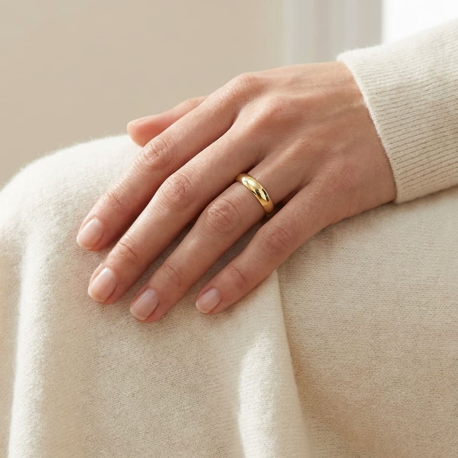 4mm Slightly Domed Traditional Oval Wedding Band in 18K Yellow Gold, worn on hand, full view