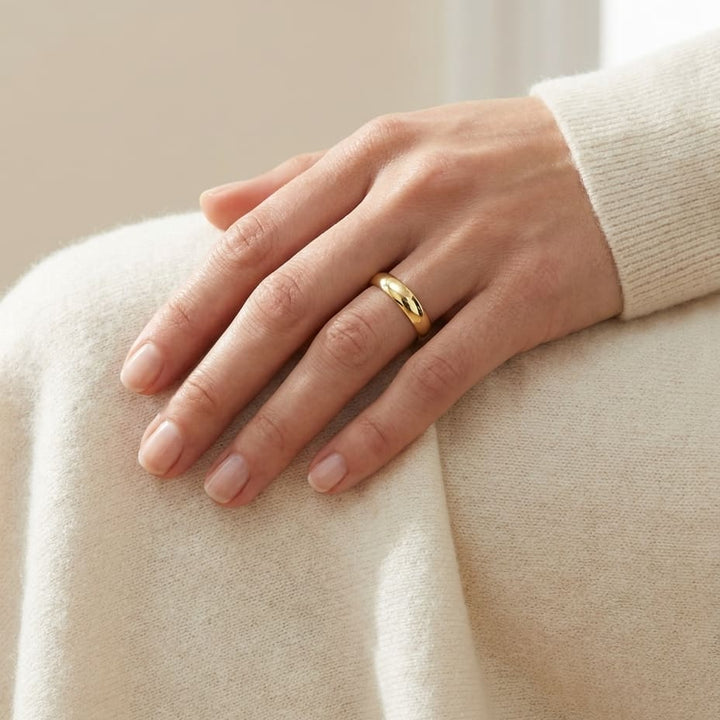 4mm Slightly Domed Traditional Oval Wedding Band in 18K Yellow Gold, worn on hand, full view
