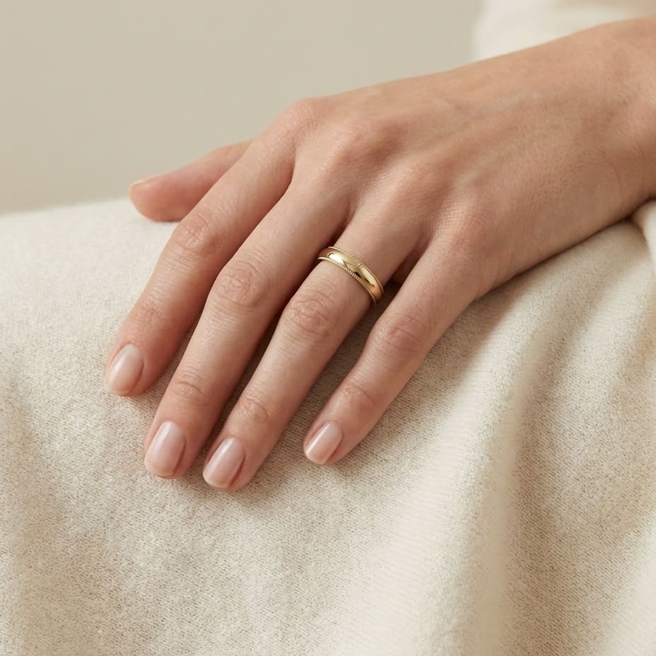 4mm Slightly Domed Traditional Oval Milgrain Wedding Band in 18K Yellow Gold, worn on hand, full view
