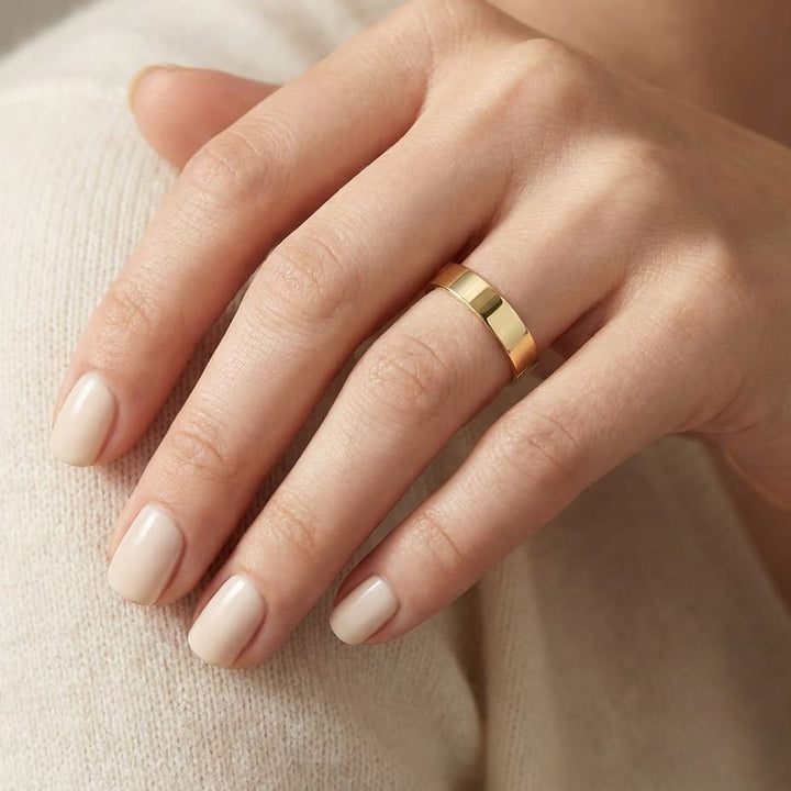 4mm Flat Comfort-Fit Wedding Band in 18K Yellow Gold, worn on hand, close-up