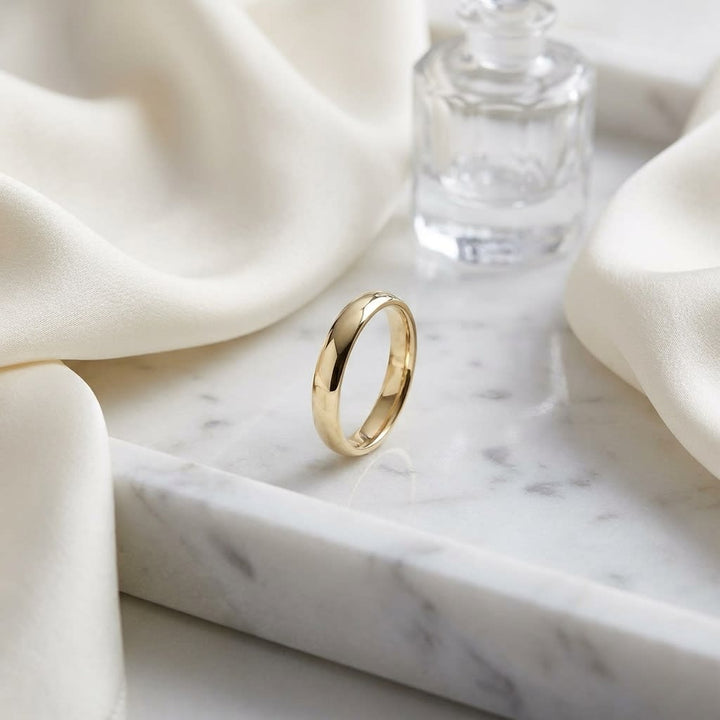 3.5mm Flat Comfort-Fit Wedding Band in 18K Yellow Gold, on marble vanity tray with silk