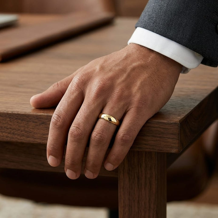 5.5mm Deluxe Comfort-Fit Wedding Band in 18K Yellow Gold, worn on hand, masculine full view