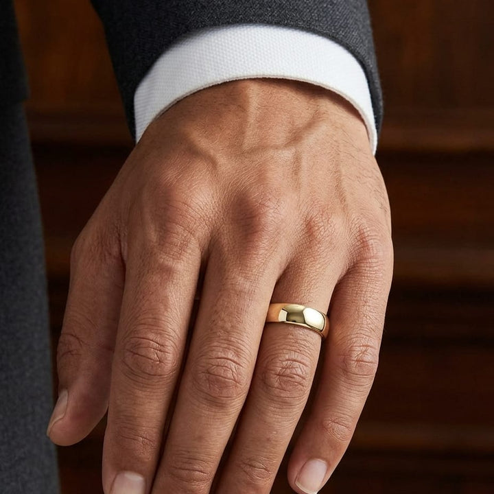 6.5mm Deluxe Comfort-Fit Wedding Band in 18K Yellow Gold, worn on hand, masculine close-up