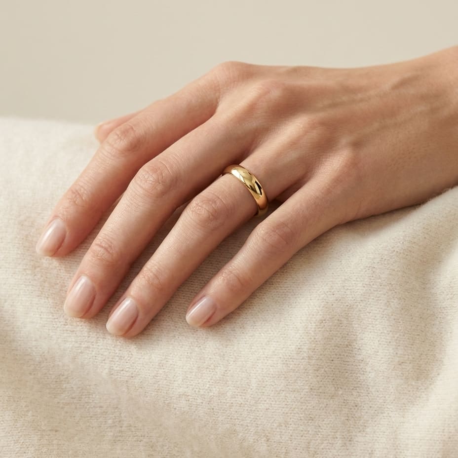 4mm High Dome Comfort-Fit Wedding Band in 18K Yellow Gold, worn on hand, full view