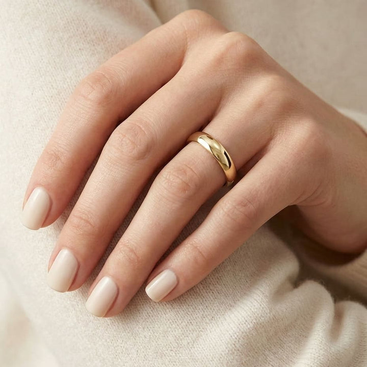 4mm Slightly Domed Comfort-Fit Wedding Band in 18K Yellow Gold, worn on hand, close-up