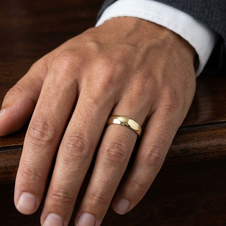 6mm Slightly Domed Comfort-Fit Wedding Band in 18K Yellow Gold, worn on hand, masculine close-up