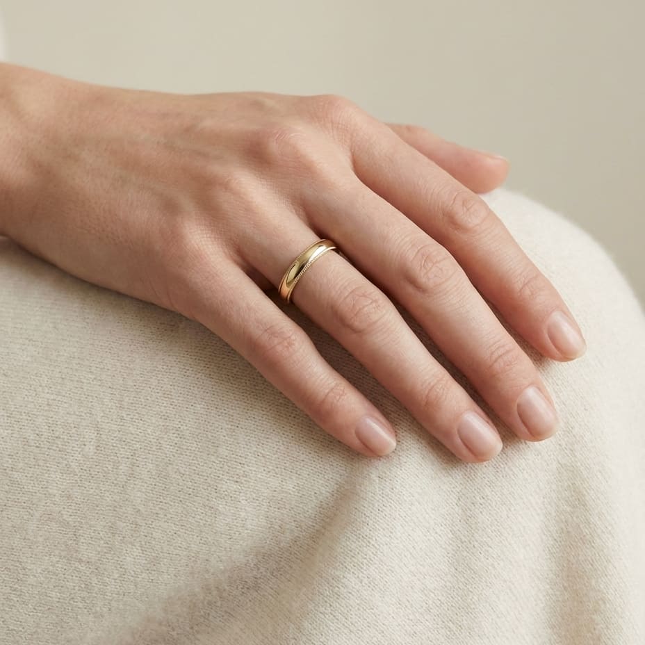 4mm Slightly Domed Milgrain Comfort-Fit Wedding Band in 18K Yellow Gold, worn on hand, full view