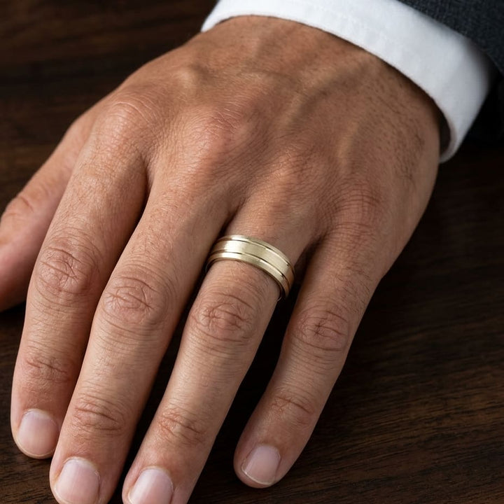 6mm Satin Finish Parallel Groove Carved Wedding Band in 18K Yellow Gold, worn on hand, masculine close-up