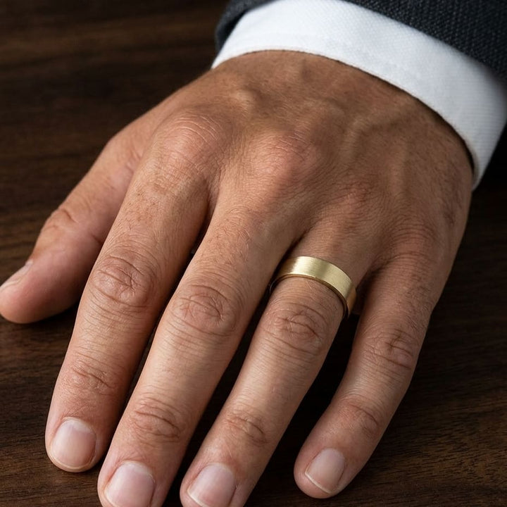 6mm Satin Finish Carved Wedding Band in 18K Yellow Gold, worn on hand, masculine close-up