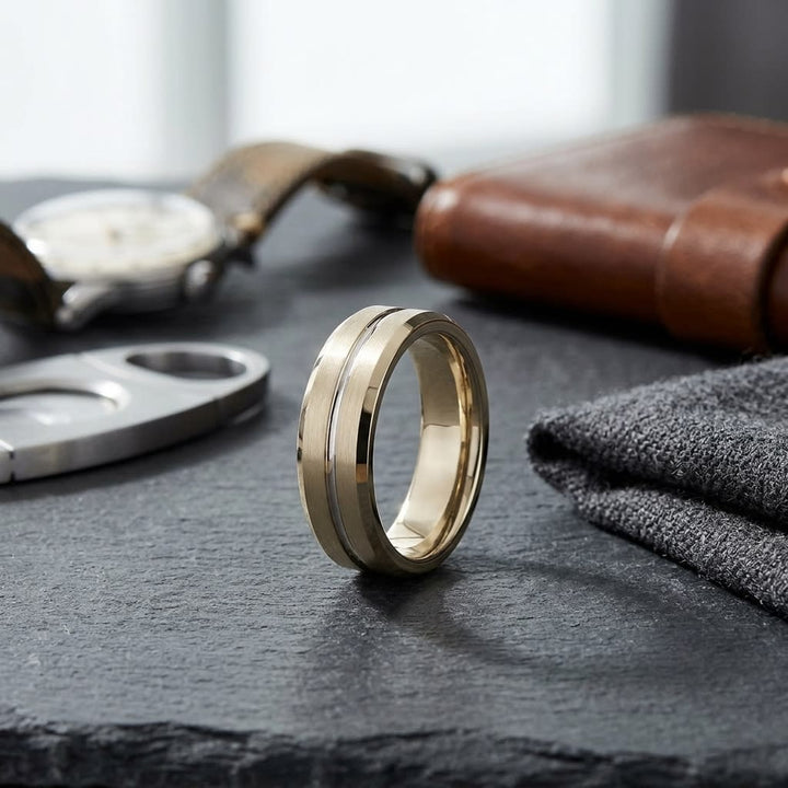 6mm Satin Finish Carved Wedding Band in 18K Yellow Gold, on walnut surface with pocket square