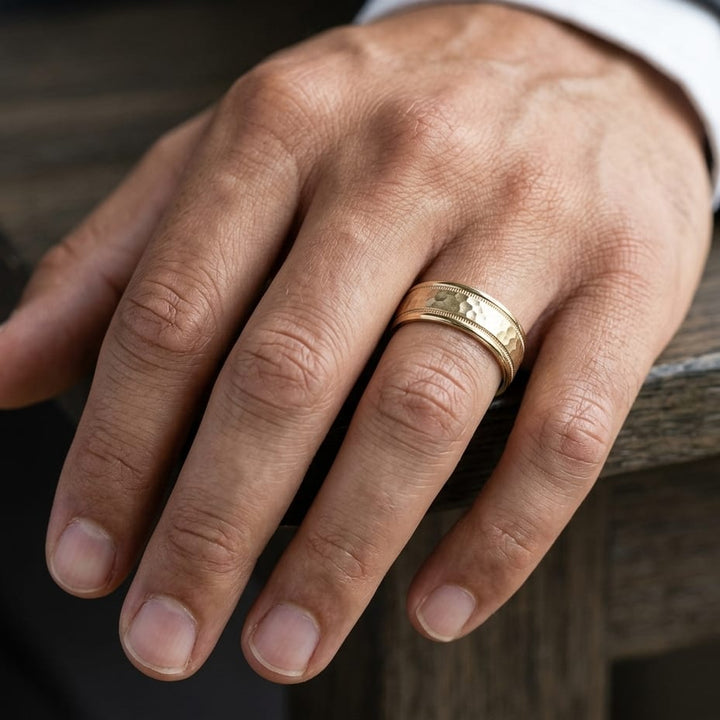 8mm Hammered Center High Polish Round Edge Carved Wedding Band in 18K Yellow Gold, worn on hand, masculine close-up