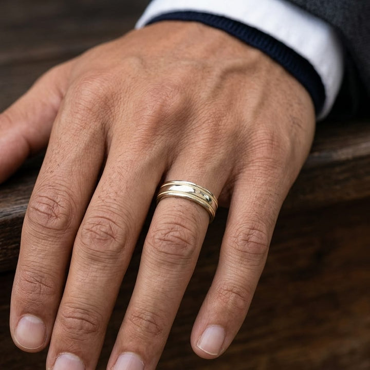 6mm High Polish Milgrain Round Edge Carved Wedding Band in 18K Yellow Gold, worn on hand, masculine close-up