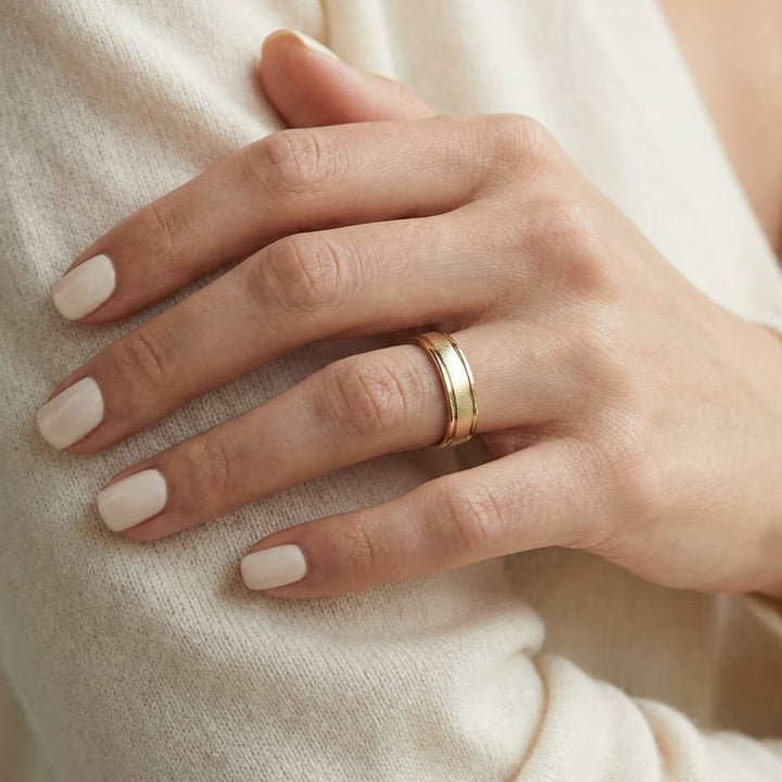 4mm Wired Finish High Polished Round Edge Carved Wedding Band in 18K Yellow Gold, worn on hand, close-up