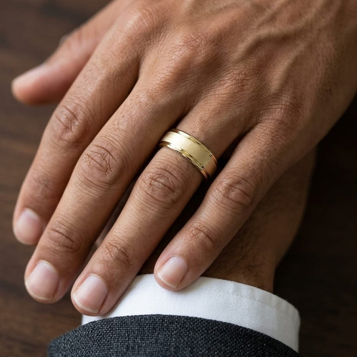 7mm Wired Finish High Polished Round Edge Carved Wedding Band in 18K Yellow Gold, worn on hand, masculine close-up
