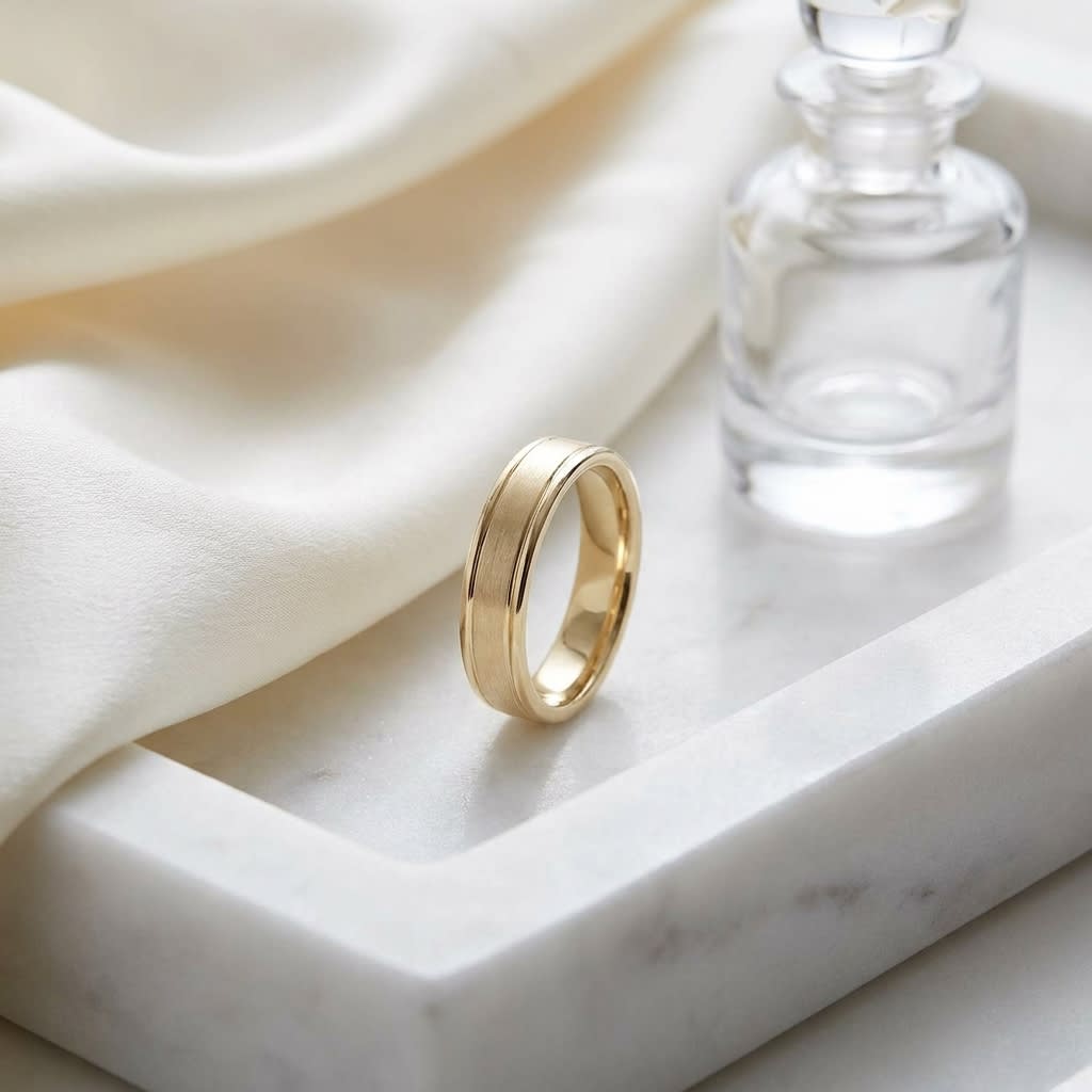 4mm Satin Finish High Polished Round Edge Carved Wedding Band in 18K Yellow Gold, on marble vanity tray with silk